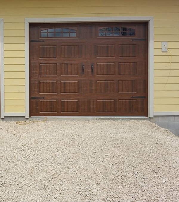 Wooden garage door on yellowhome in Geo City