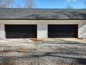 Residential Garage Door Installation of an 18x8 model 65 gloss black. These doors have a 20 year fade proof guarantee on the exterior paint.