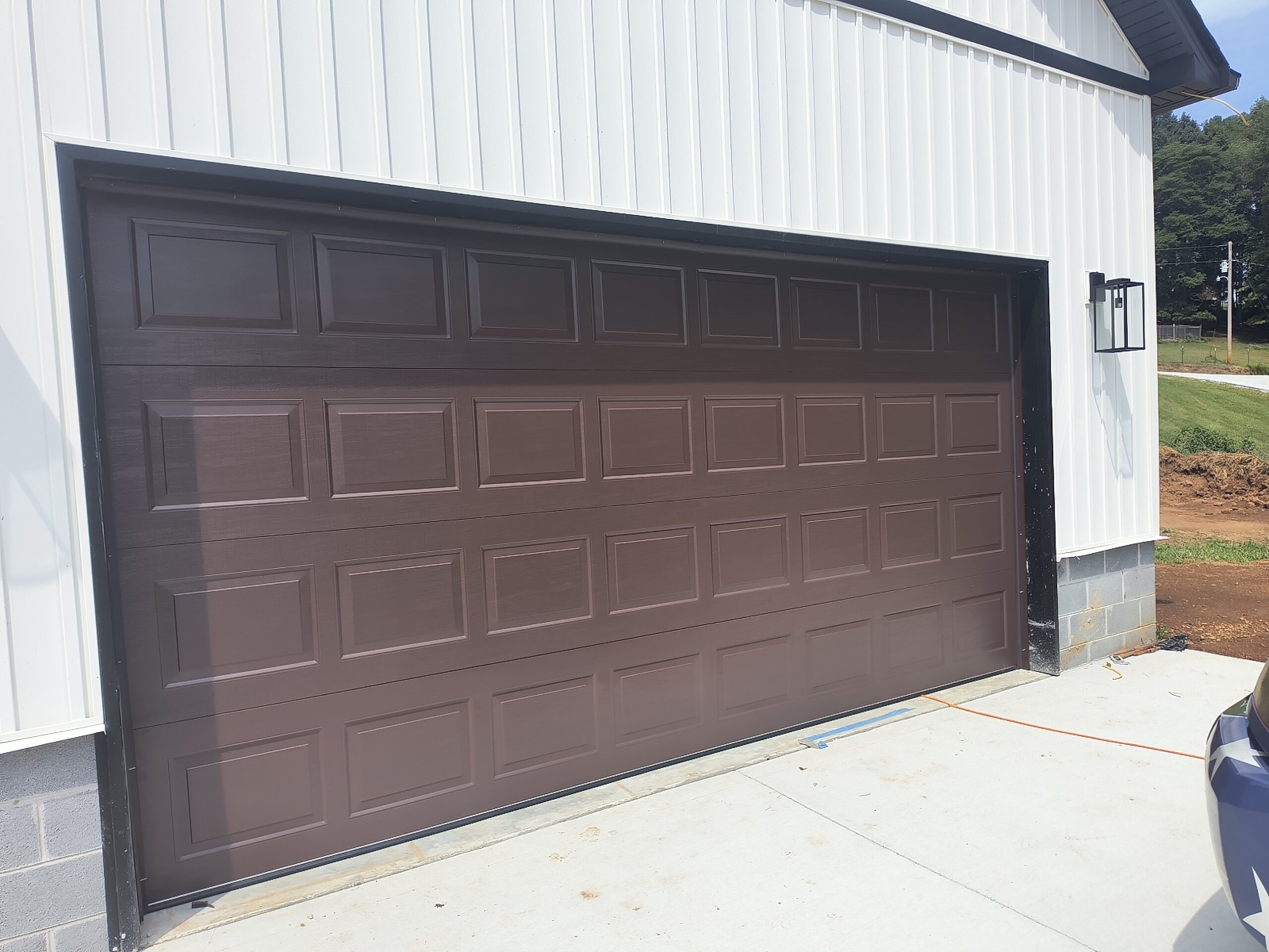 Large brown garage door on white building